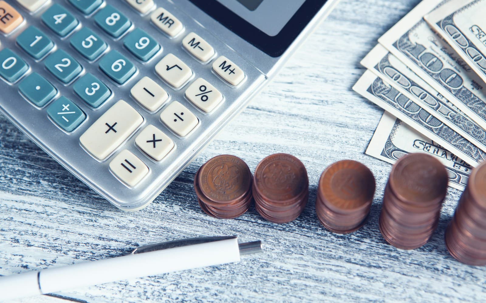 Unsplash payroll and pensions wallpaper with calculator and money detail